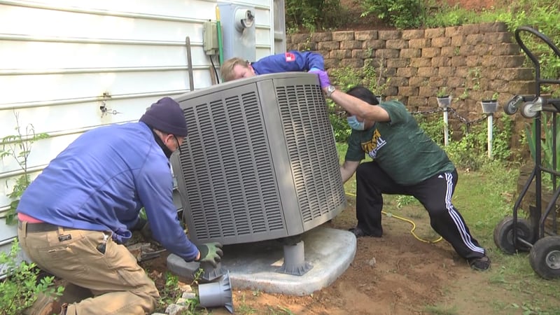 Crew members from Beck Cohen and AHIP install new HVAC system for a Charlottesville family.