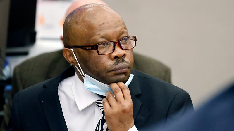 FILE - Defendant Billy Chemirmir lowers his mask as a state witness is asked to identify him...
