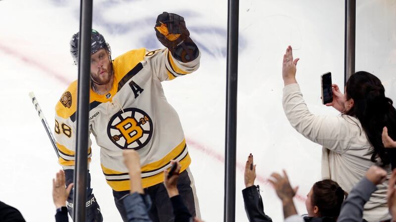 Boston Bruins' David Pastrnak celebrates after scoring on a penalty shot during the third...