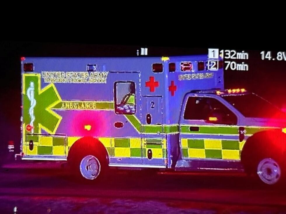 An ambulance leaves the scene of a Blackhawk crash in Cadiz, Kentucky.