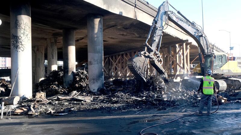 Crews continue to clear debris and shore up a stretch of Interstate 10, Tuesday morning Nov....
