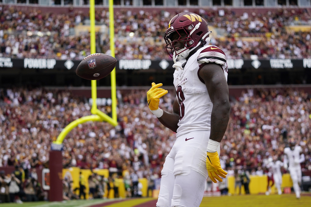Washington Commanders running back Brian Robinson Jr. (8) reacts after scoring a touchdown...