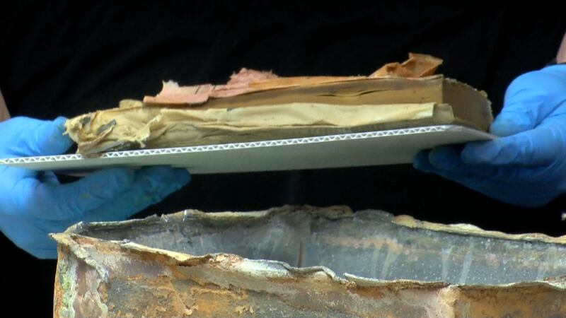 Three books, a coin and a cloth envelope were found inside a lead box believed to be the time...