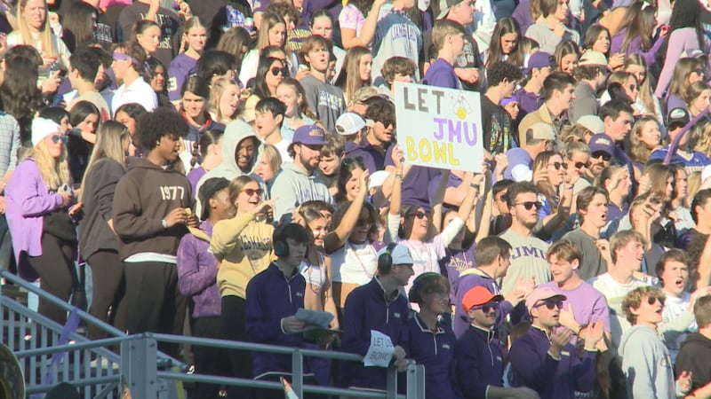 A James Madison fan holds up a sign, "Let them bowl," during a football game against UConn on...