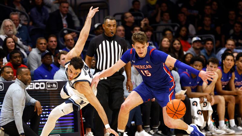American forward Matt Rogers (15) and Villanova forward Tyler Burton (23) scramble for the...